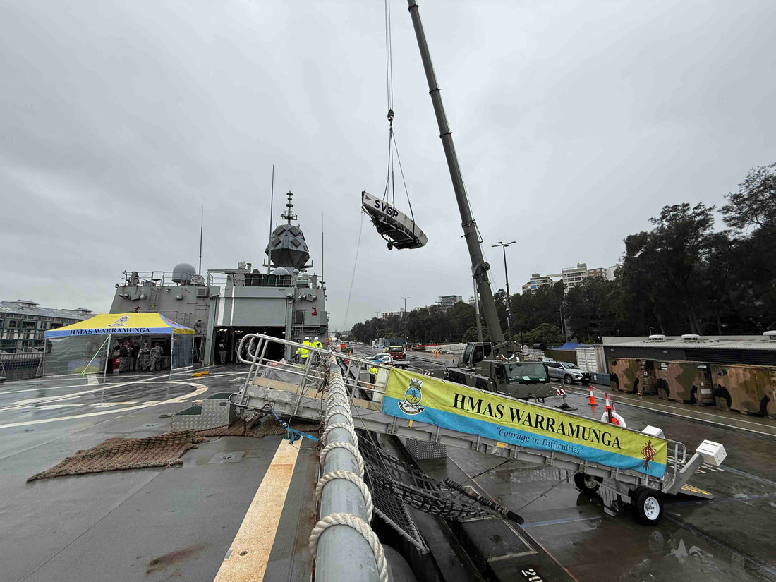 HMAS Warramunga unloading the Saltwater Veterans Sailing Project Elliott 7 onto the wharf at HMAS Kuttabul, Sydney.