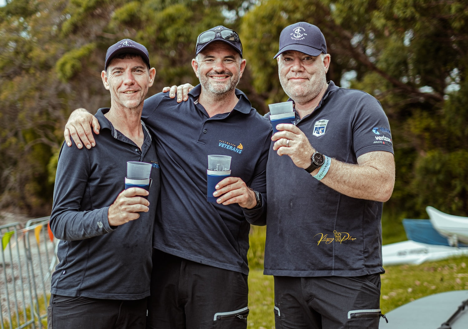 Three Saltwater Veterans Sailing Project participants sharing time together off the water, enjoying conversation and camaraderie.